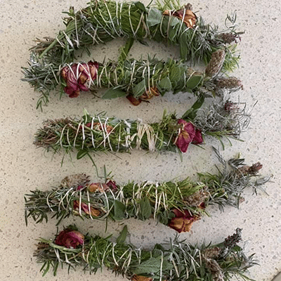 Smudge cleansing sticks - $15 – made from fresh organic Sage, Lavender, Rosemary, Tea Tree, & Rose petals.